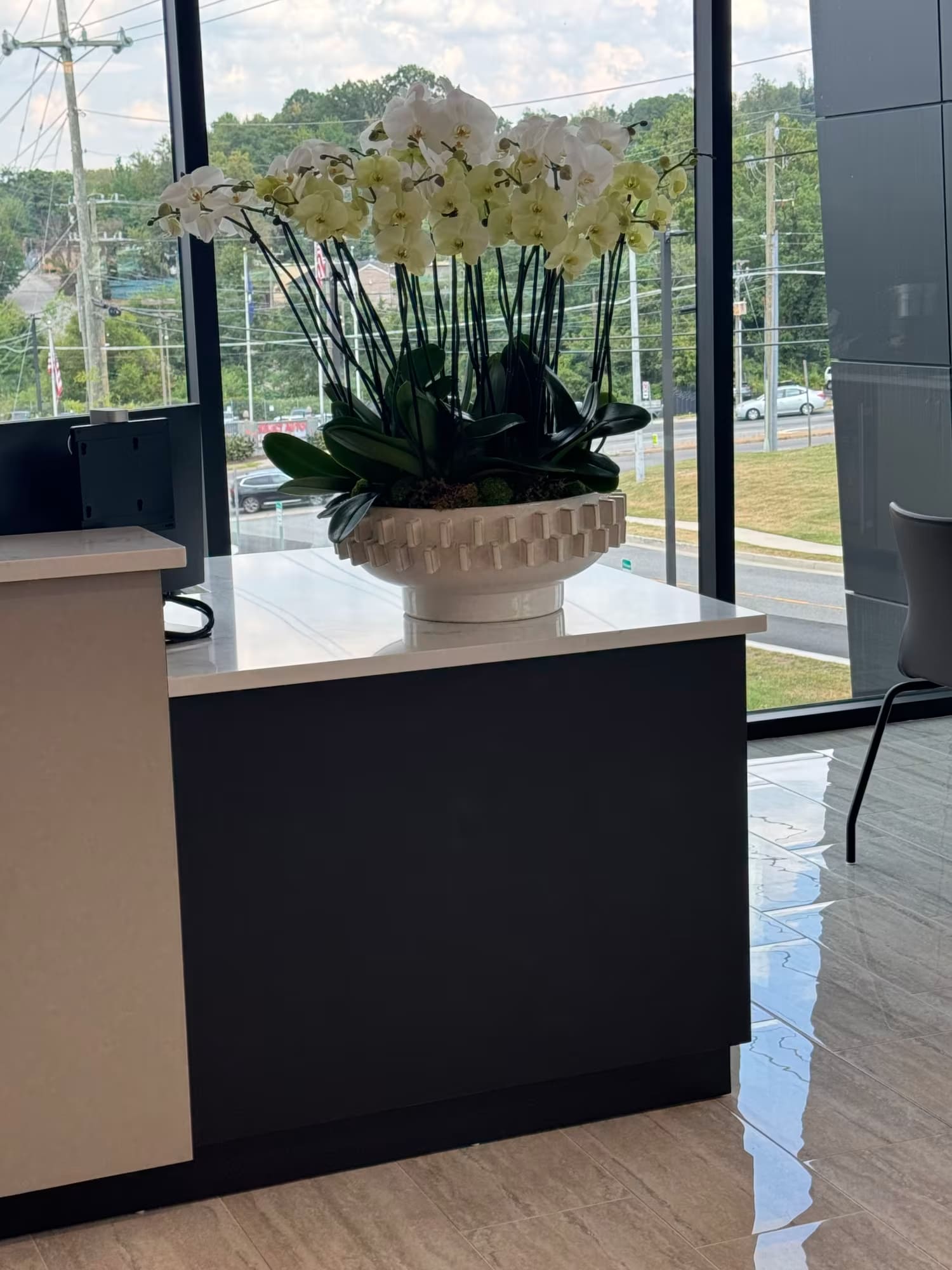 Monthly orchid arrangement at Select Auto Import Alexandria VA | Ultimate Floral Designs floral service