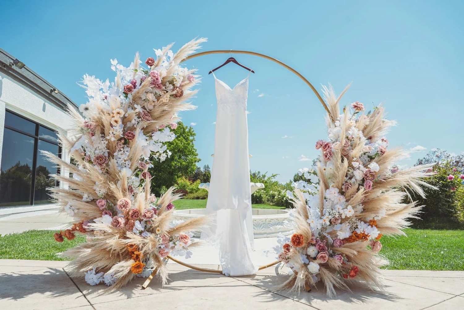 Wedding dress hung on circular floral piece