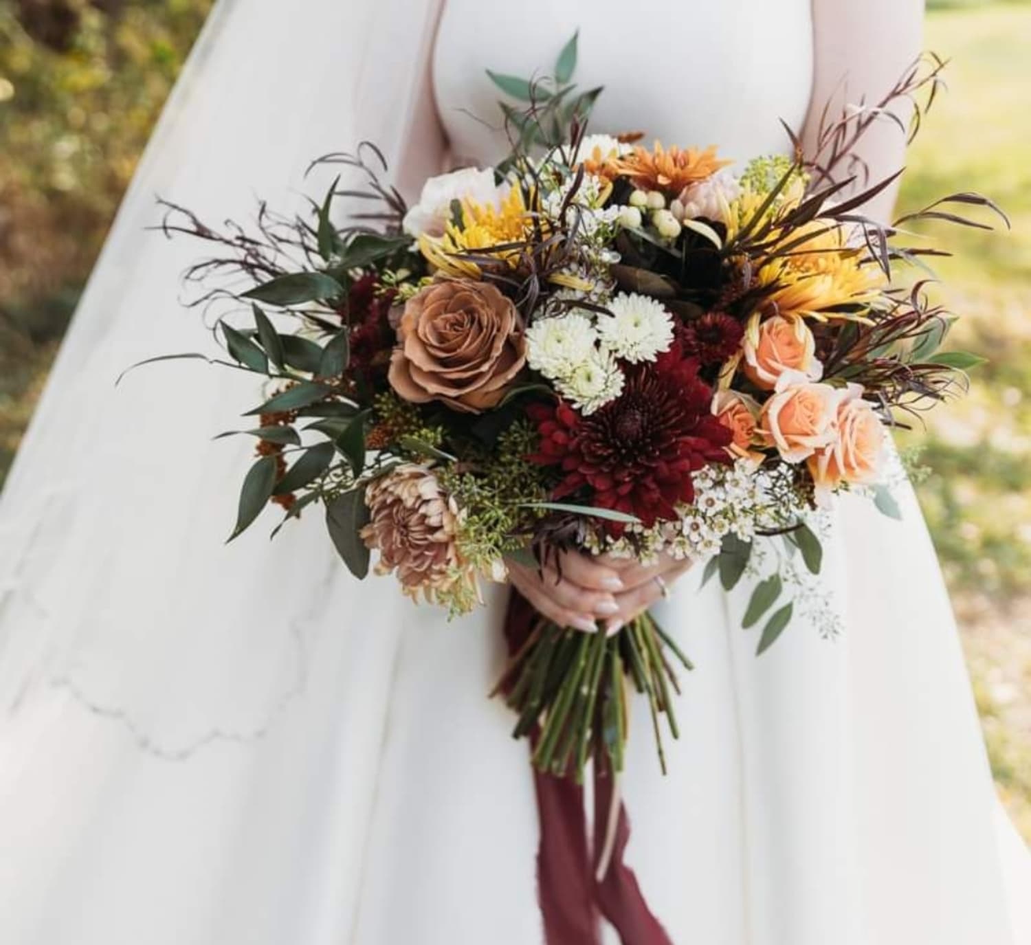 Bridal bouquet with reds, browns, and oranges