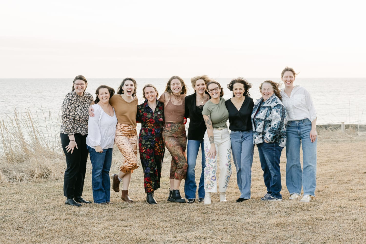 A photo of some of Botanique's team on a windy day by the ocean.