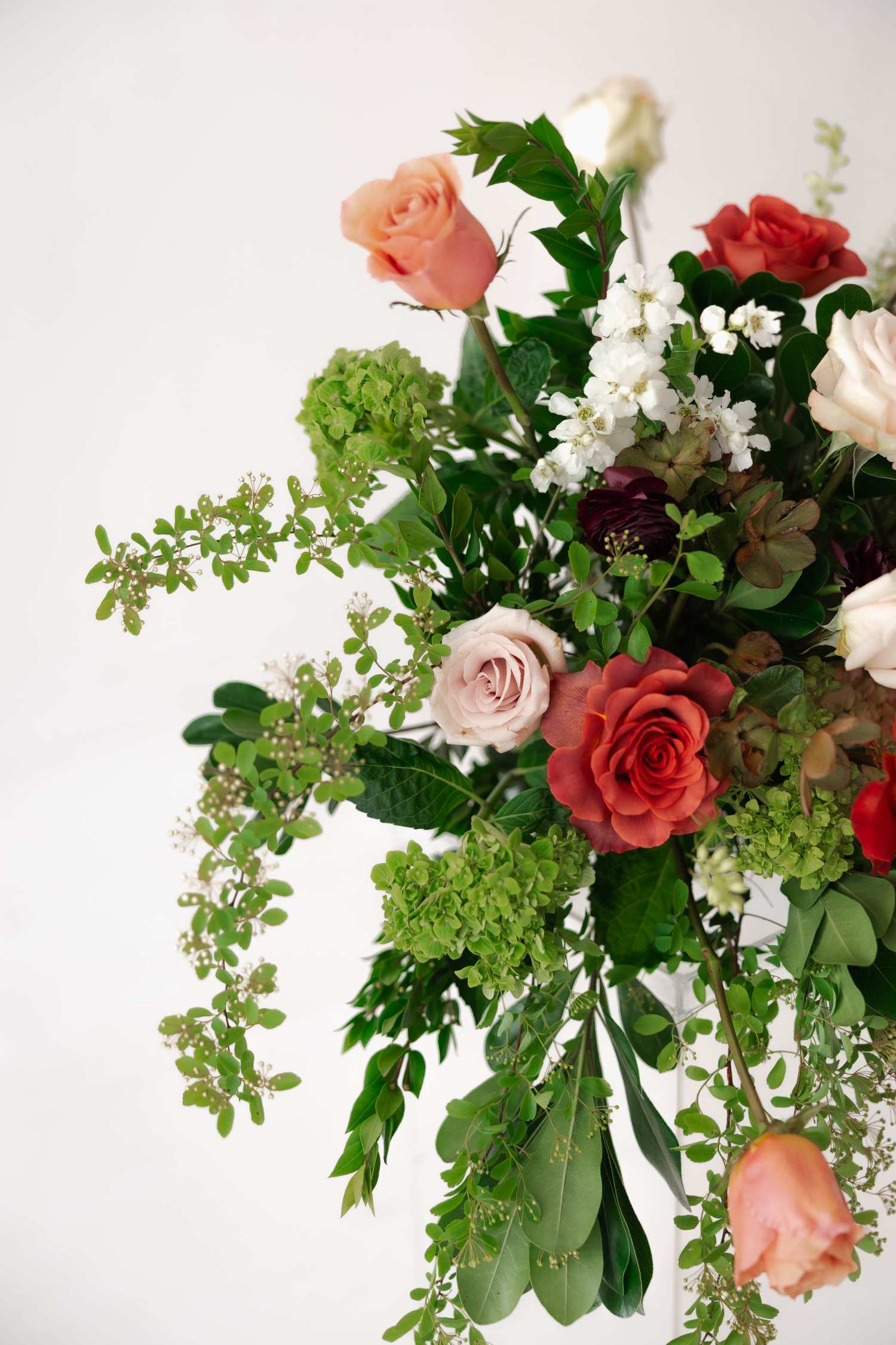 Close up of red and orange rose arrangement