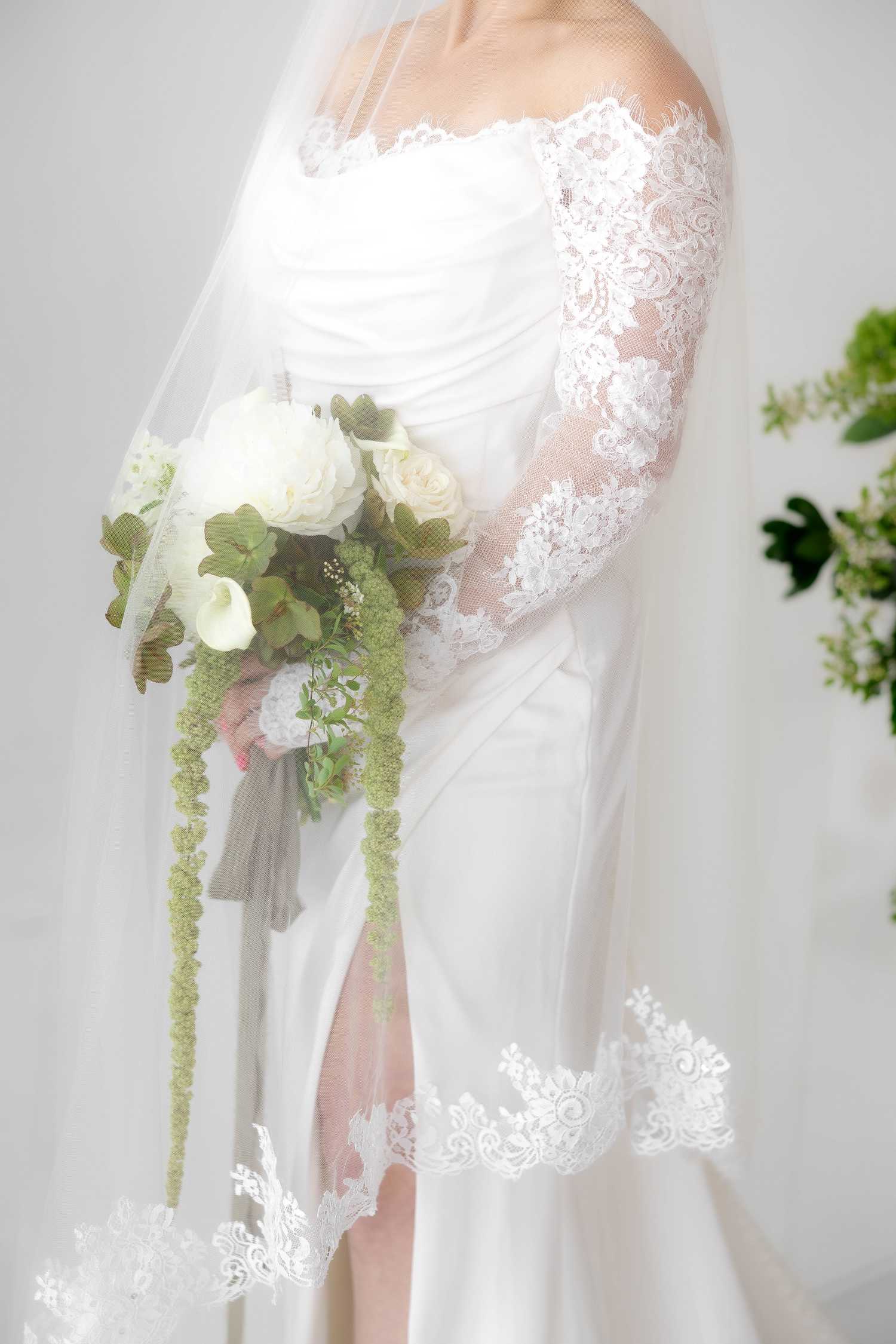Bride with bouquet under veil