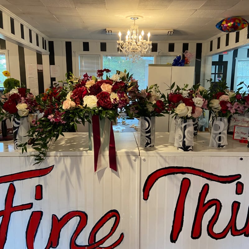 Coordinated red and white floral arrangements displayed together.