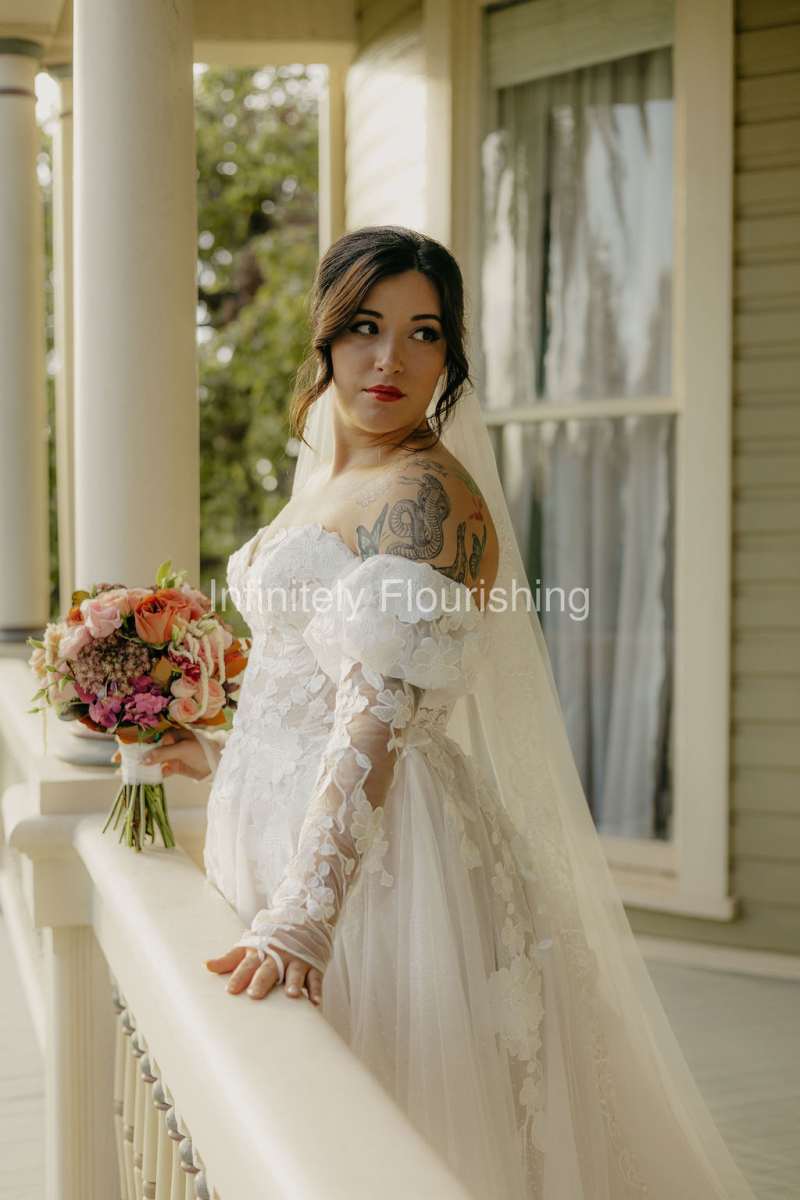 Featuring barista roses, blush roses, light pink lisianthus, raspberry hydrangea, copper beech leaves, preserved white hanging amaranthus, and chocolate Queen Anne's lace, the bouquet blends rich autumn tones with soft feminine details.