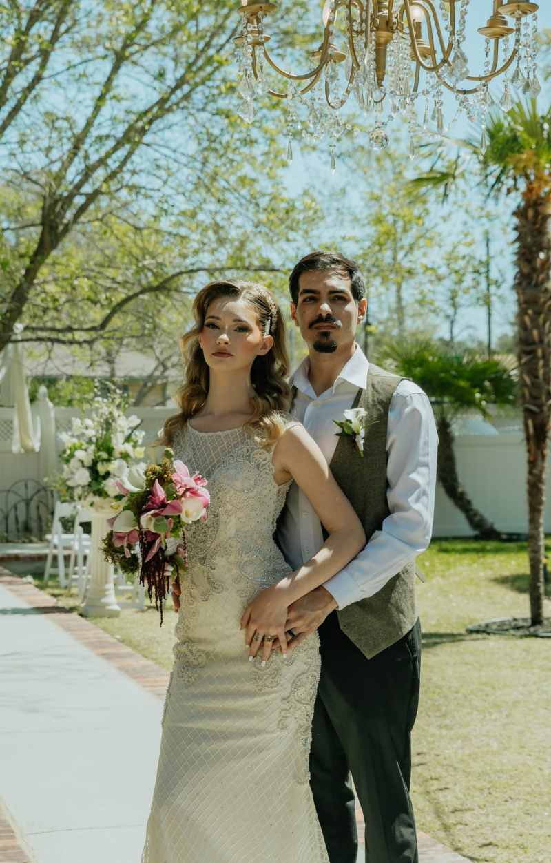 Featuring sculptural green hydrangea, white calla lilies, burgundy cymbidium orchids, cascading burgundy amaranthus, green poppy pods, and a dramatic moss sphere, the bouquet was created to feel both timeless and unexpected.The groom's boutonnière complem