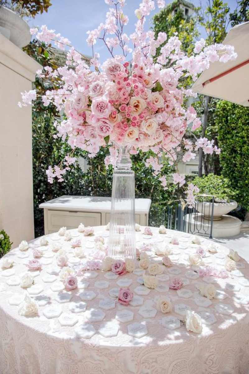 Pink and white wedding ceremony floral installation with aisle flowers.