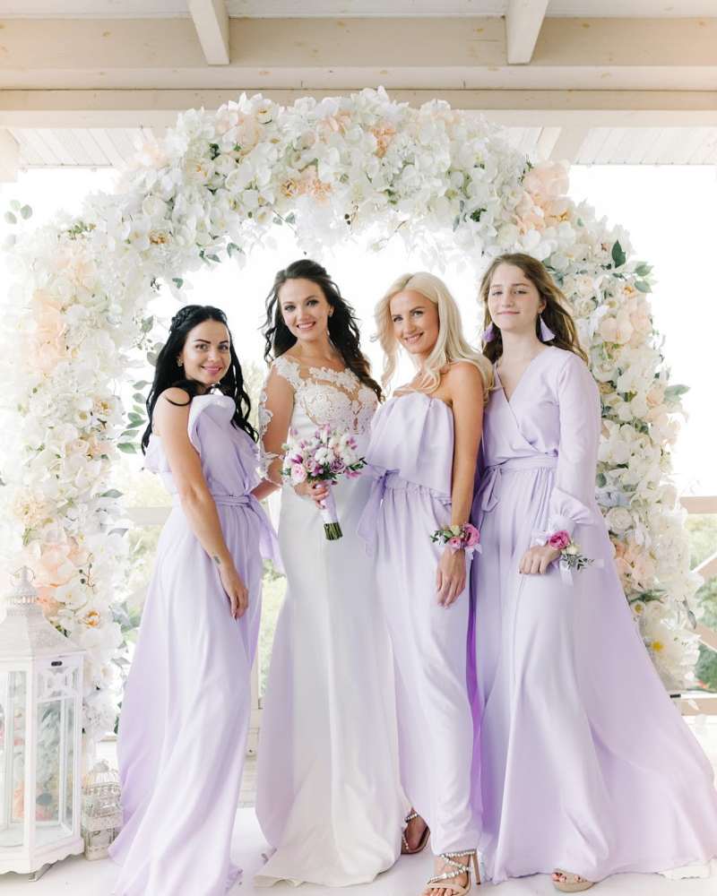Bridesmaids holding white wedding bouquets in Coconut Grove.