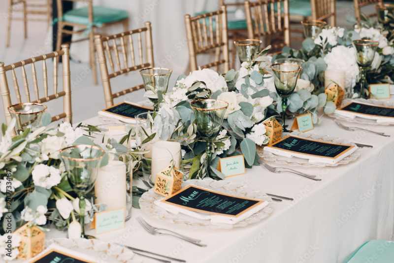 White and green wedding reception table flowers with elegant centerpieces.