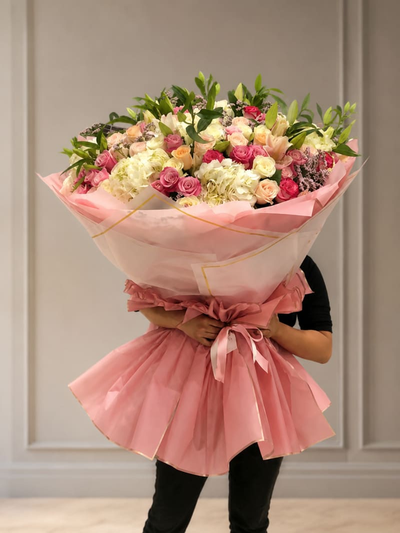 Pink wrapped luxury bouquet with roses.