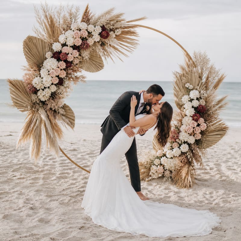 Boho wedding arch with pampas flowers on the beach.