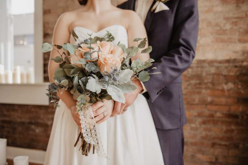 Bride holding a white bridal bouquet.