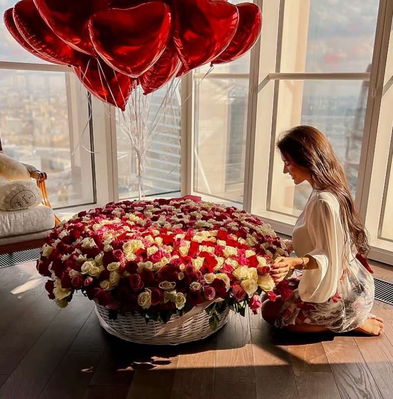 Red rose basket arrangement with romantic décor.