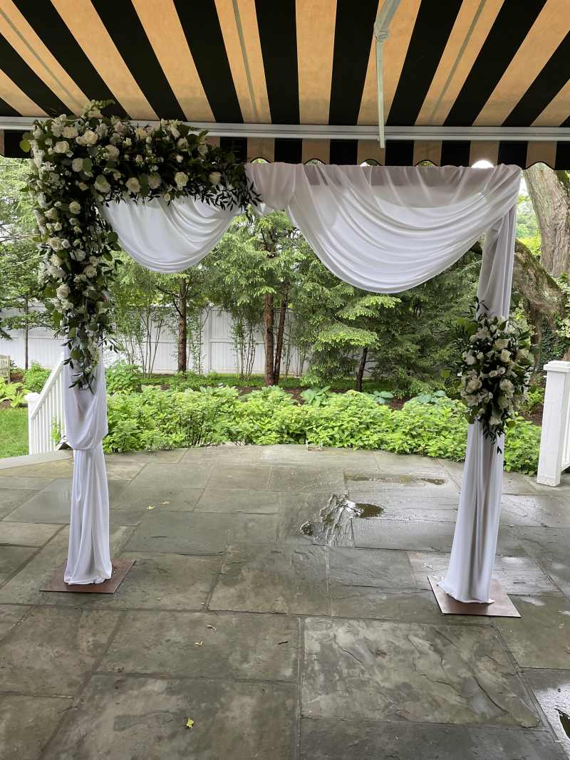 Arch with flowers and drapes.