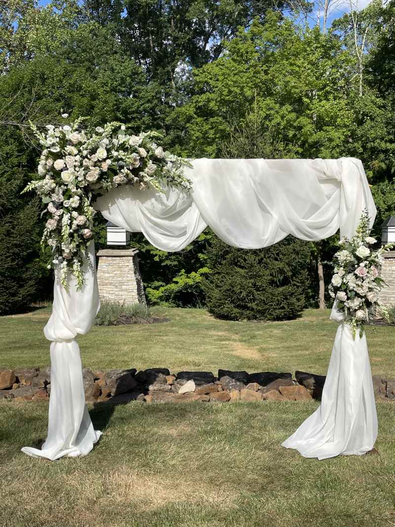 Arch with flowers and sheer.