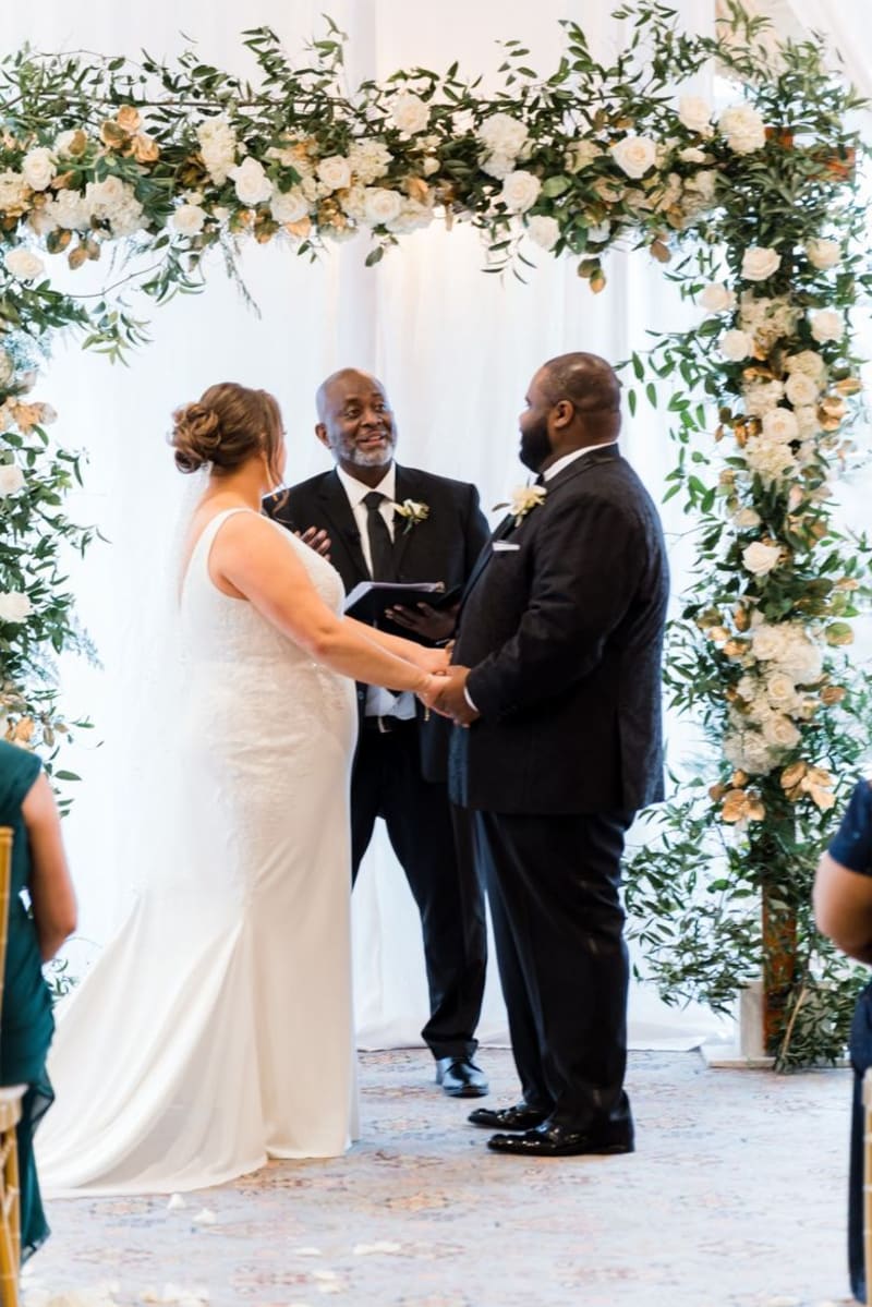 White wedding bouquets and arch