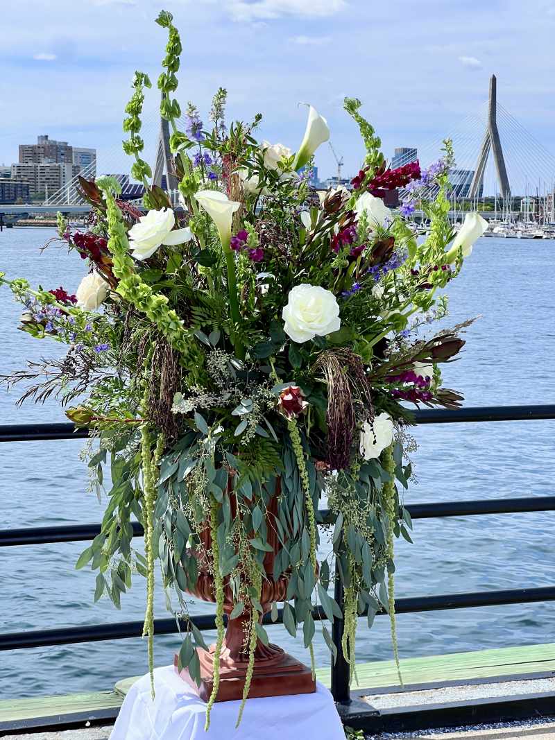 Grand wedding pedestal ceremony flower tall arrangement outside closeup