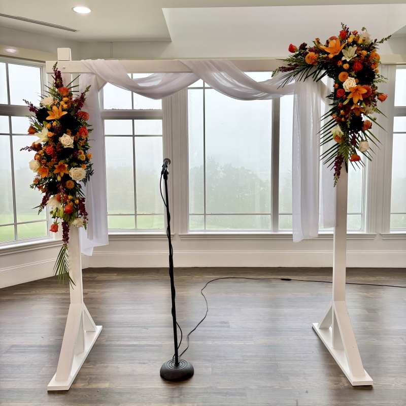 Flower sprays on wedding arch for ceremony