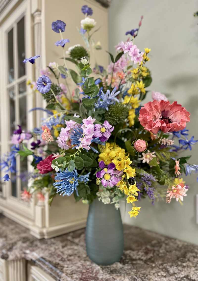 Colorful garden-style floral arrangement with seasonal flowers by Legacy Florals & Gifts