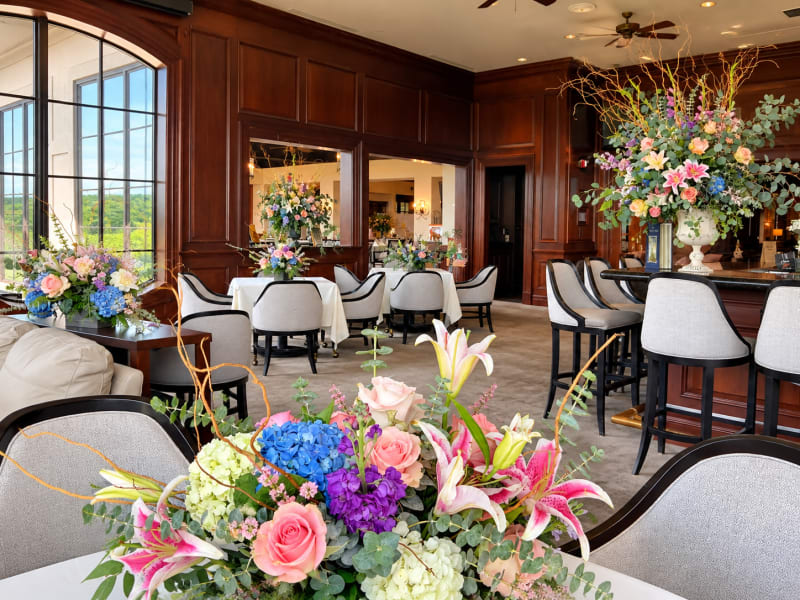Elegant event venue decorated with custom floral centerpieces and large statement arrangements by Legacy Florals & Gifts.