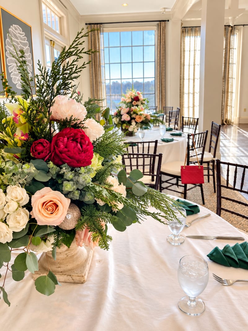 Elegant floral centerpiece with roses and greenery at a special event by Legacy Florals & Gifts